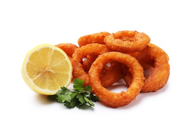 Photo of Fried squid rings, lemon and parsley isolated on white