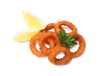 Photo of Fried squid rings, lemon and parsley isolated on white, top view