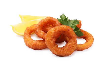 Photo of Fried squid rings, lemon and parsley isolated on white