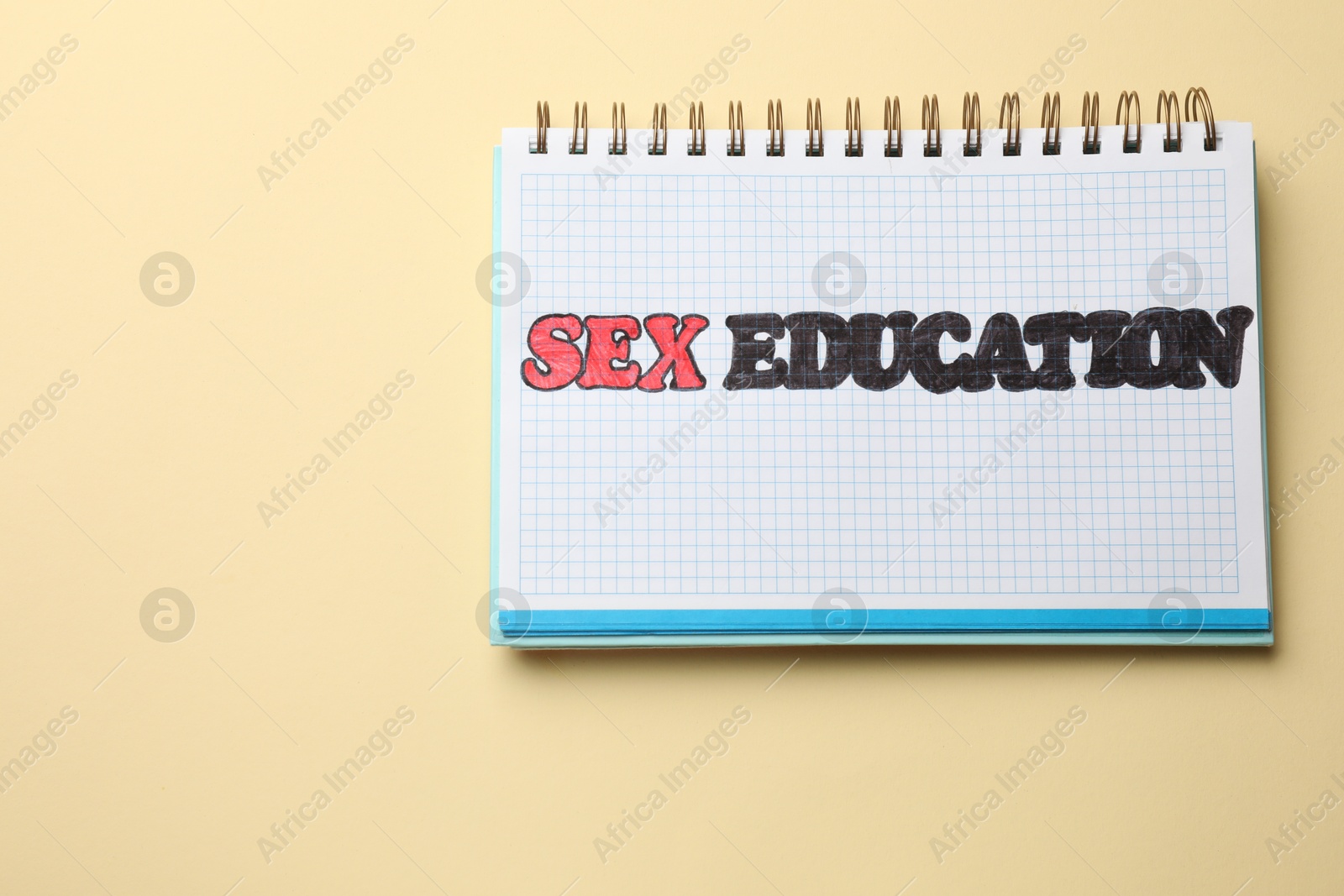 Photo of Notebook with words Sex Education on beige background, top view. Space for text