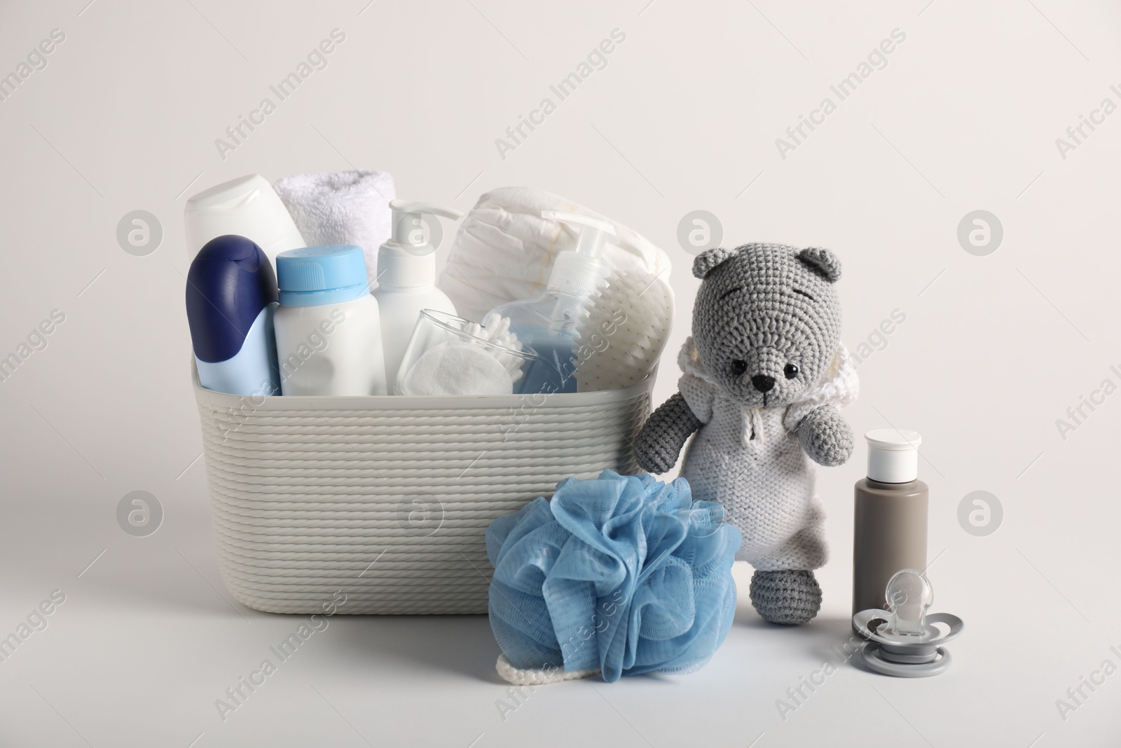 Baby accessories and body care products on light grey background Photo of Baby accessories and body care products on light grey background