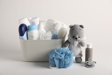 Photo of Baby accessories and body care products on light grey background