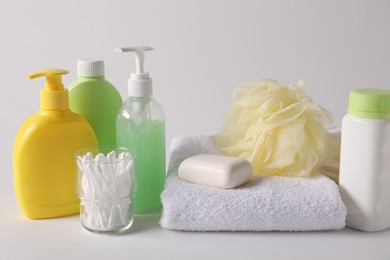 Photo of Baby accessories and body care products on light grey background, closeup