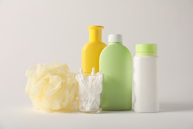 Photo of Baby accessories and body care products on light grey background