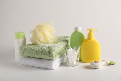 Photo of Baby accessories and body care products on light grey background