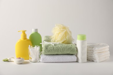 Photo of Baby accessories and body care products on light grey background