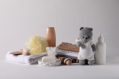 Photo of Baby accessories, clothes and body care products on light grey background