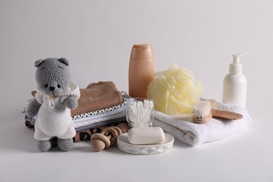 Photo of Baby accessories, clothes and body care products on light grey background