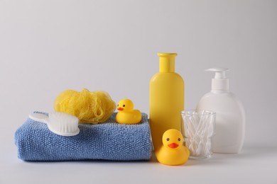 Photo of Baby accessories and body care products on light grey background