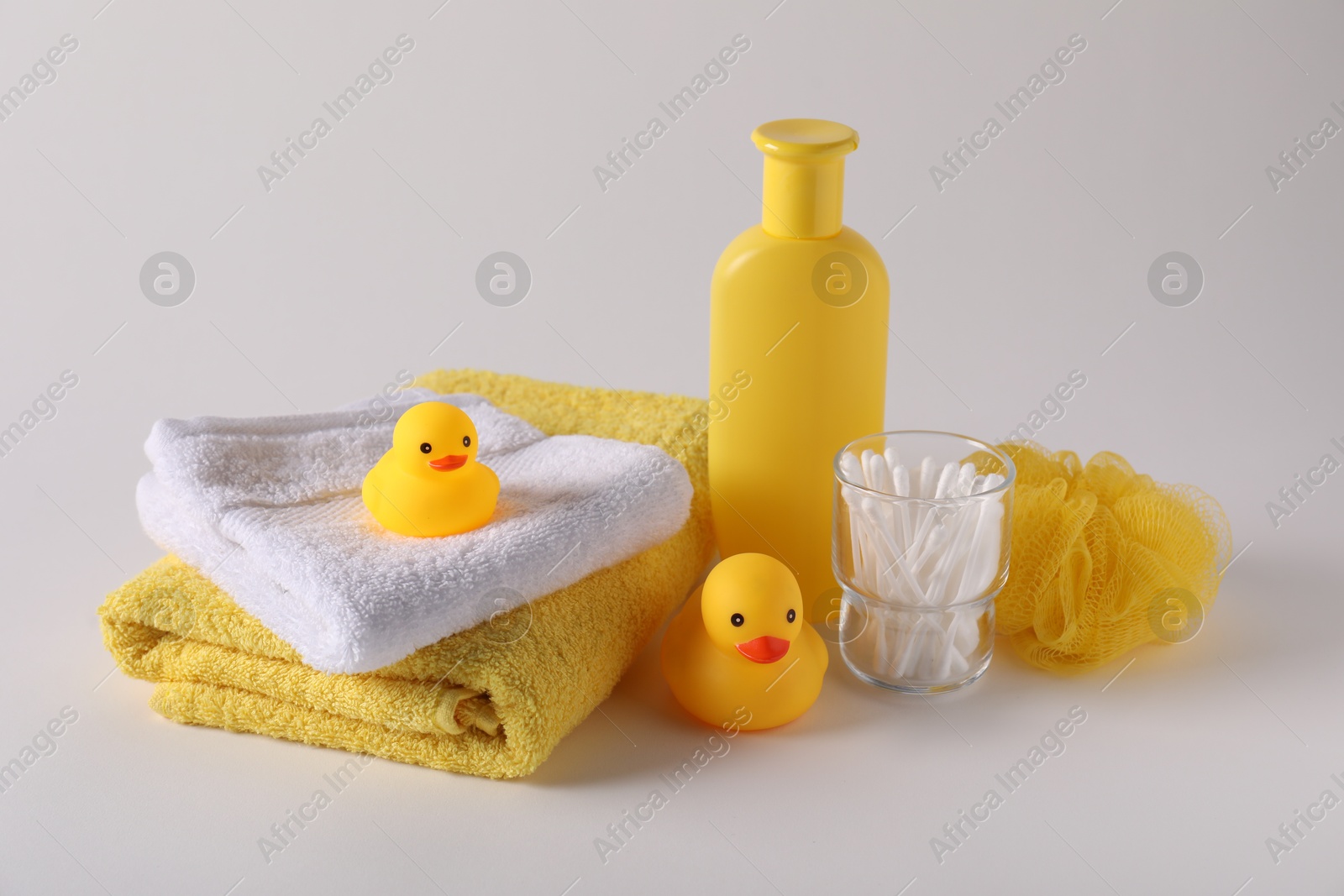 Baby accessories and body care products on light grey background Photo of Baby accessories and body care products on light grey background