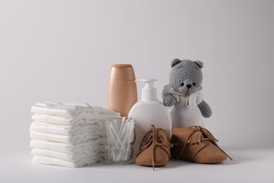 Photo of Baby accessories and body care products on light grey background