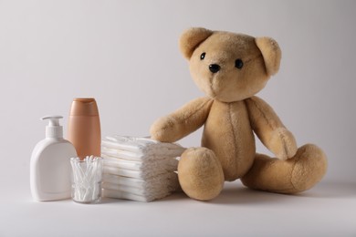 Photo of Baby accessories and body care products on light grey background