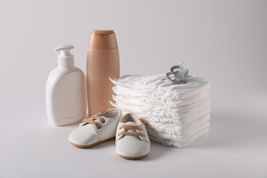 Photo of Baby accessories and body care products on light grey background