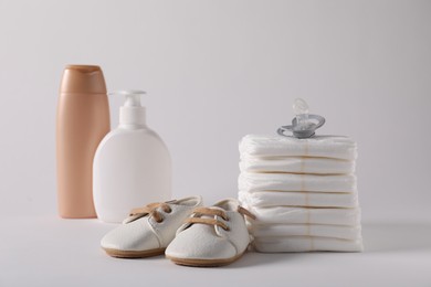 Photo of Baby accessories and body care products on light grey background