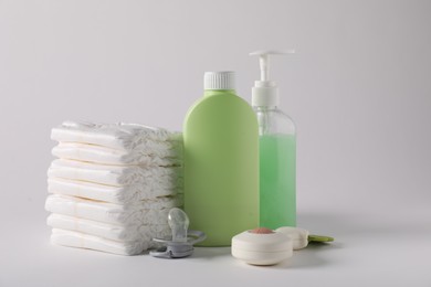 Photo of Baby accessories and body care products on light grey background