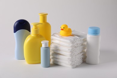 Photo of Baby accessories and body care products on light grey background