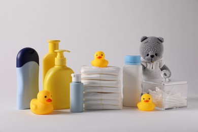Photo of Baby accessories and body care products on light grey background