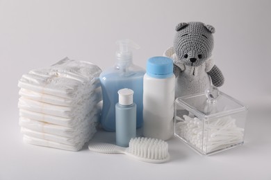 Photo of Baby accessories and body care products on light grey background