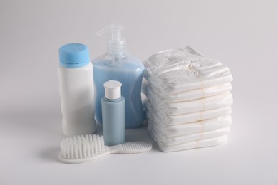 Photo of Baby accessories and body care products on light grey background