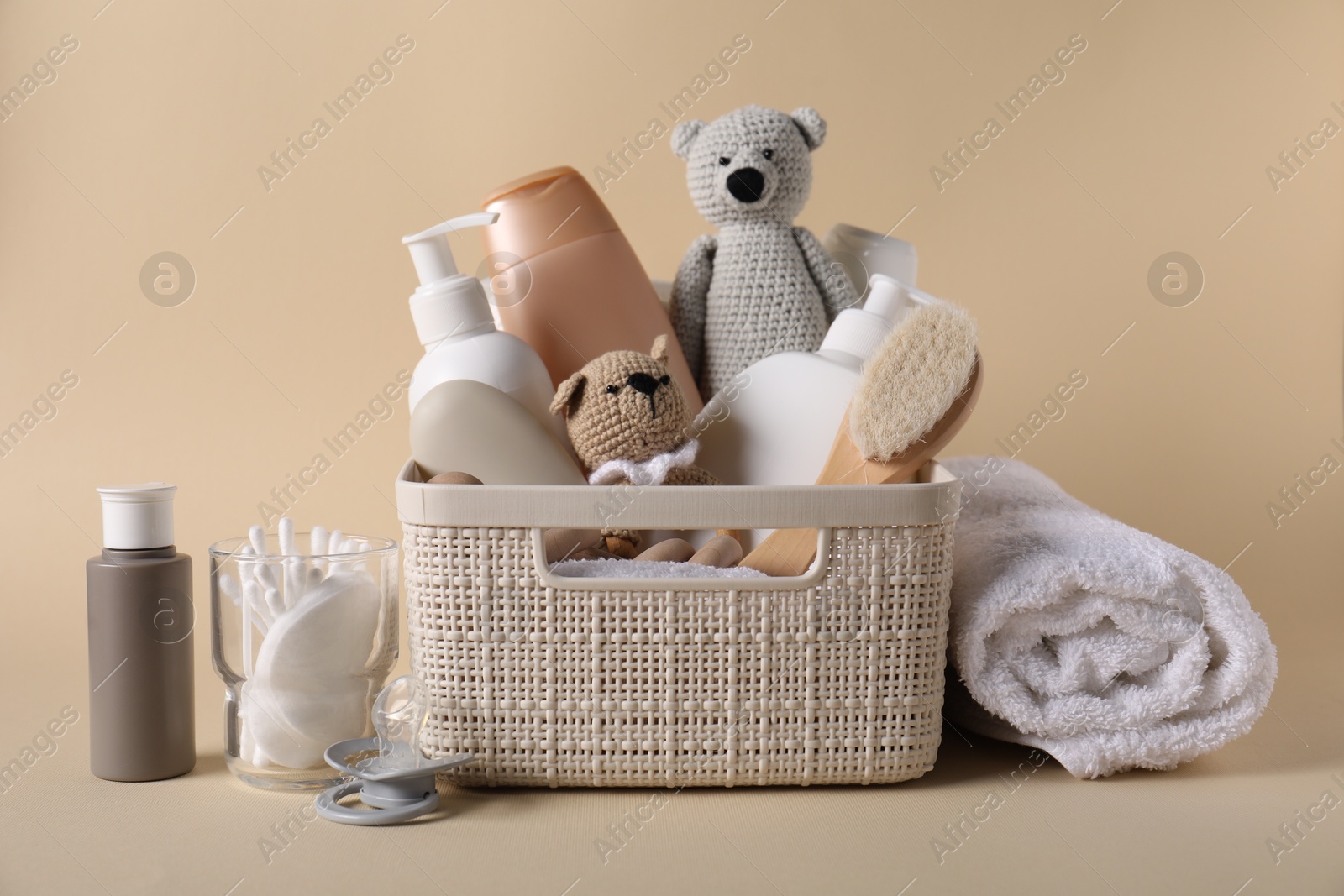 Baby accessories and body care products on beige background Photo of Baby accessories and body care products on beige background