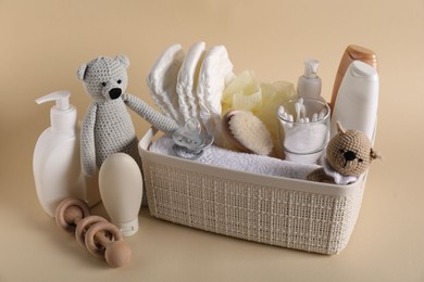 Photo of Baby accessories and body care products on beige background