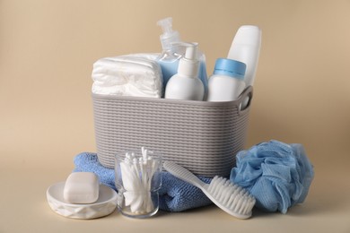 Photo of Baby accessories and body care products on beige background