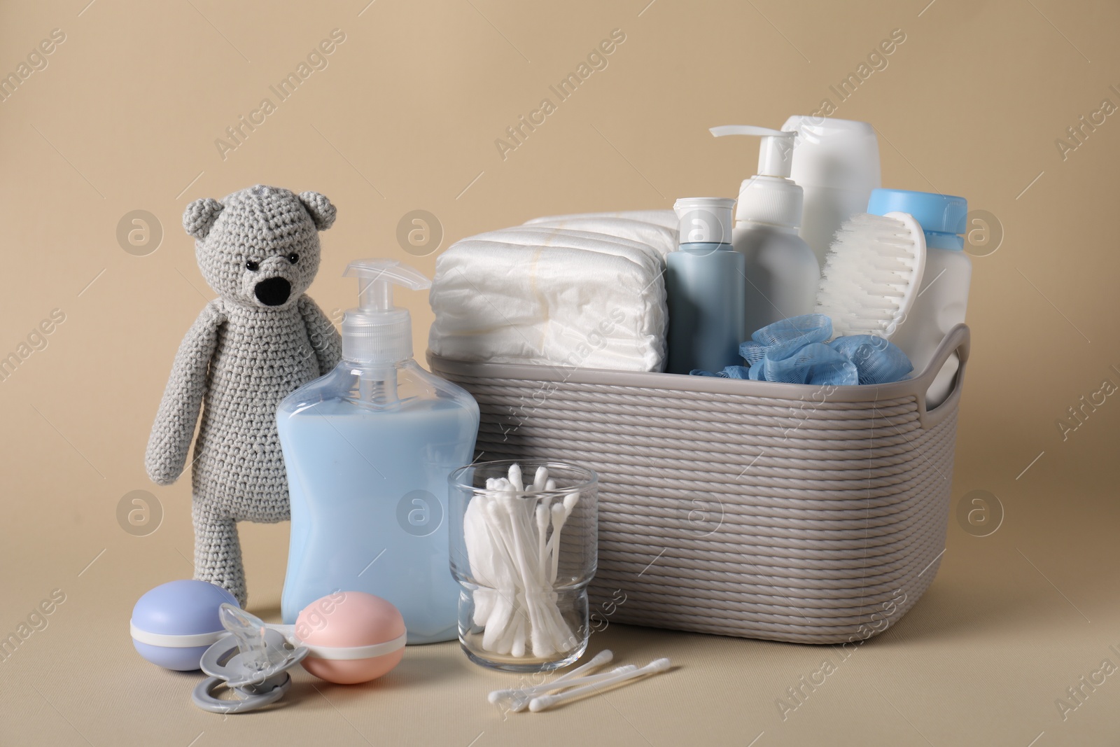 Photo of Baby accessories and body care products on beige background