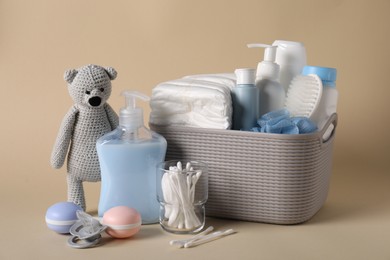 Photo of Baby accessories and body care products on beige background