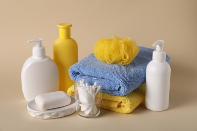 Photo of Baby accessories and body care products on beige background