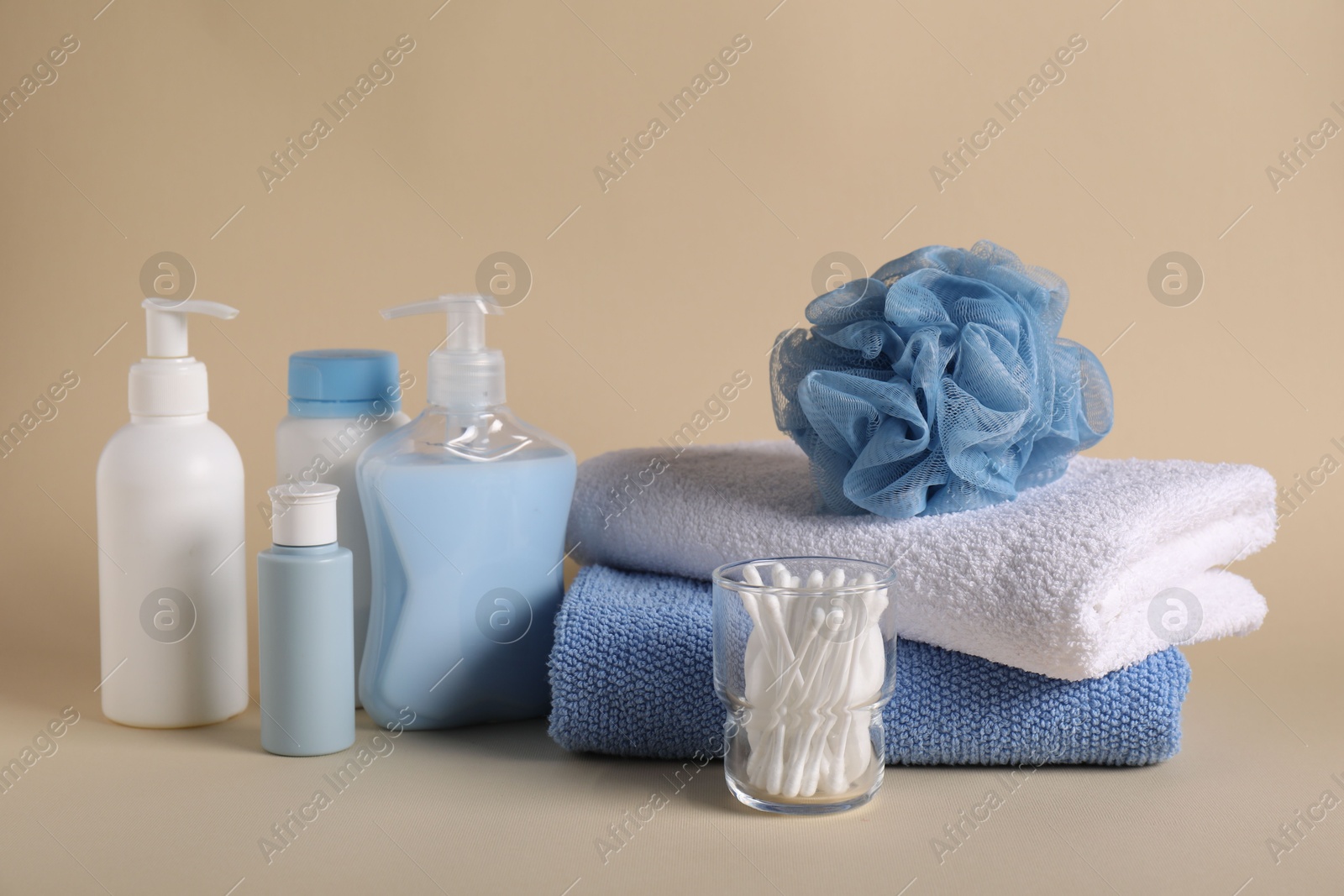 Photo of Baby accessories and body care products on beige background