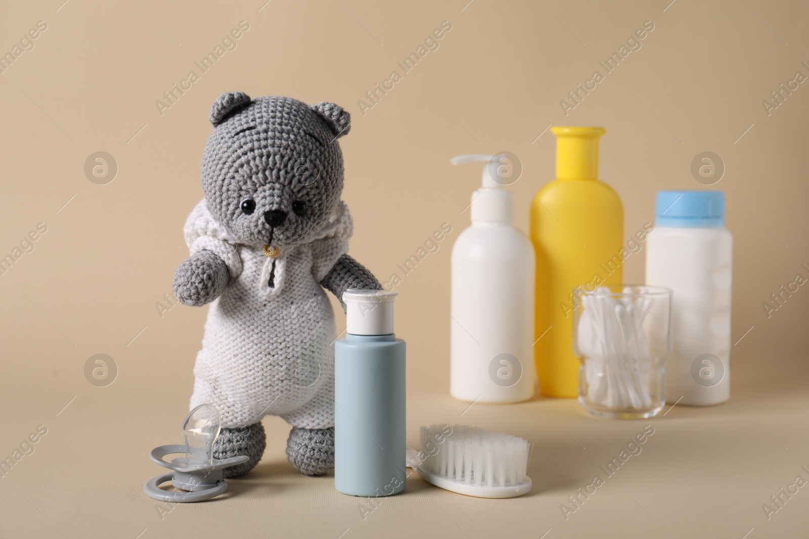 Photo of Baby accessories and body care products on beige background