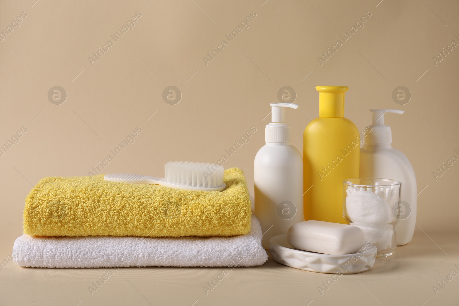 Photo of Baby accessories and body care products on beige background