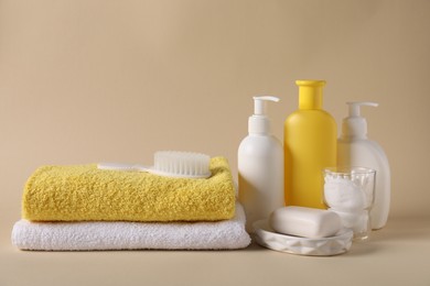 Photo of Baby accessories and body care products on beige background