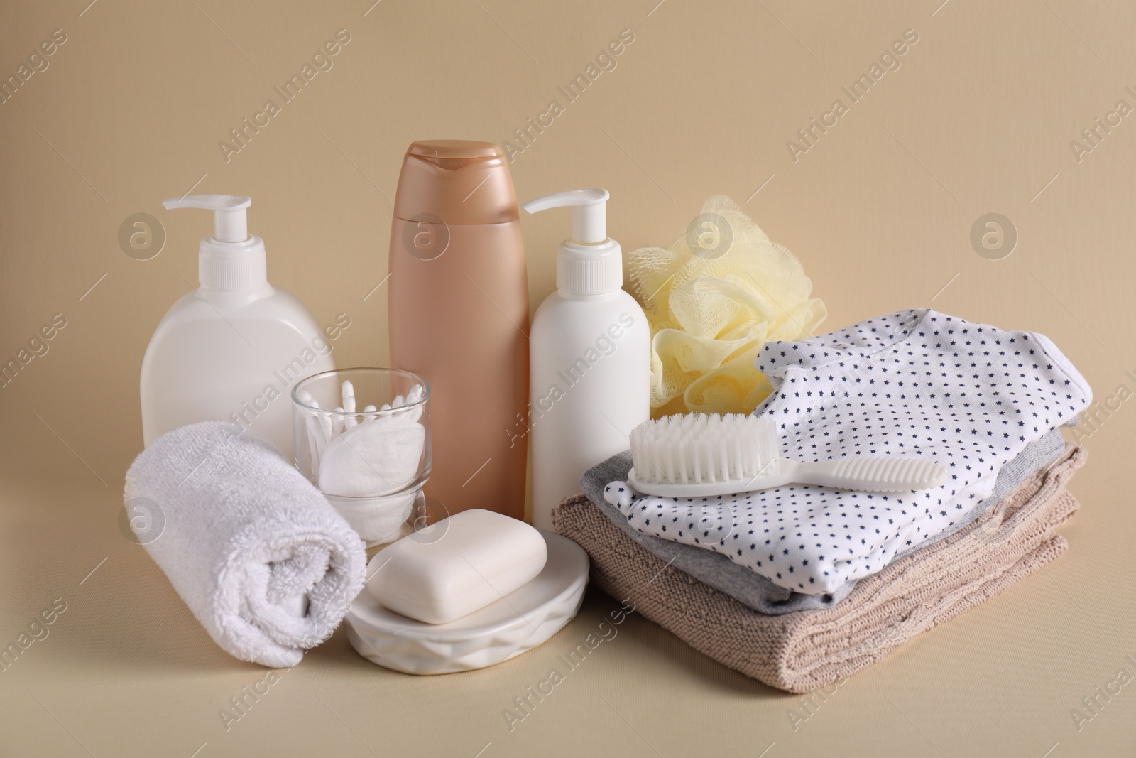 Photo of Baby accessories, clothes and body care products on beige background