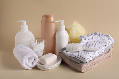 Photo of Baby accessories, clothes and body care products on beige background