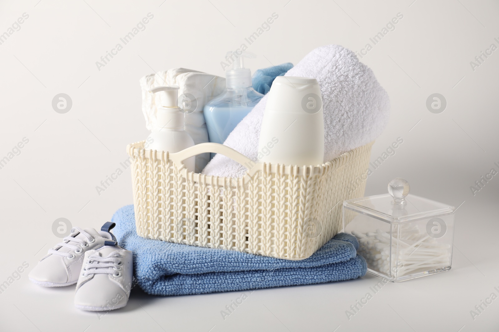Photo of Baby accessories and body care products on light background