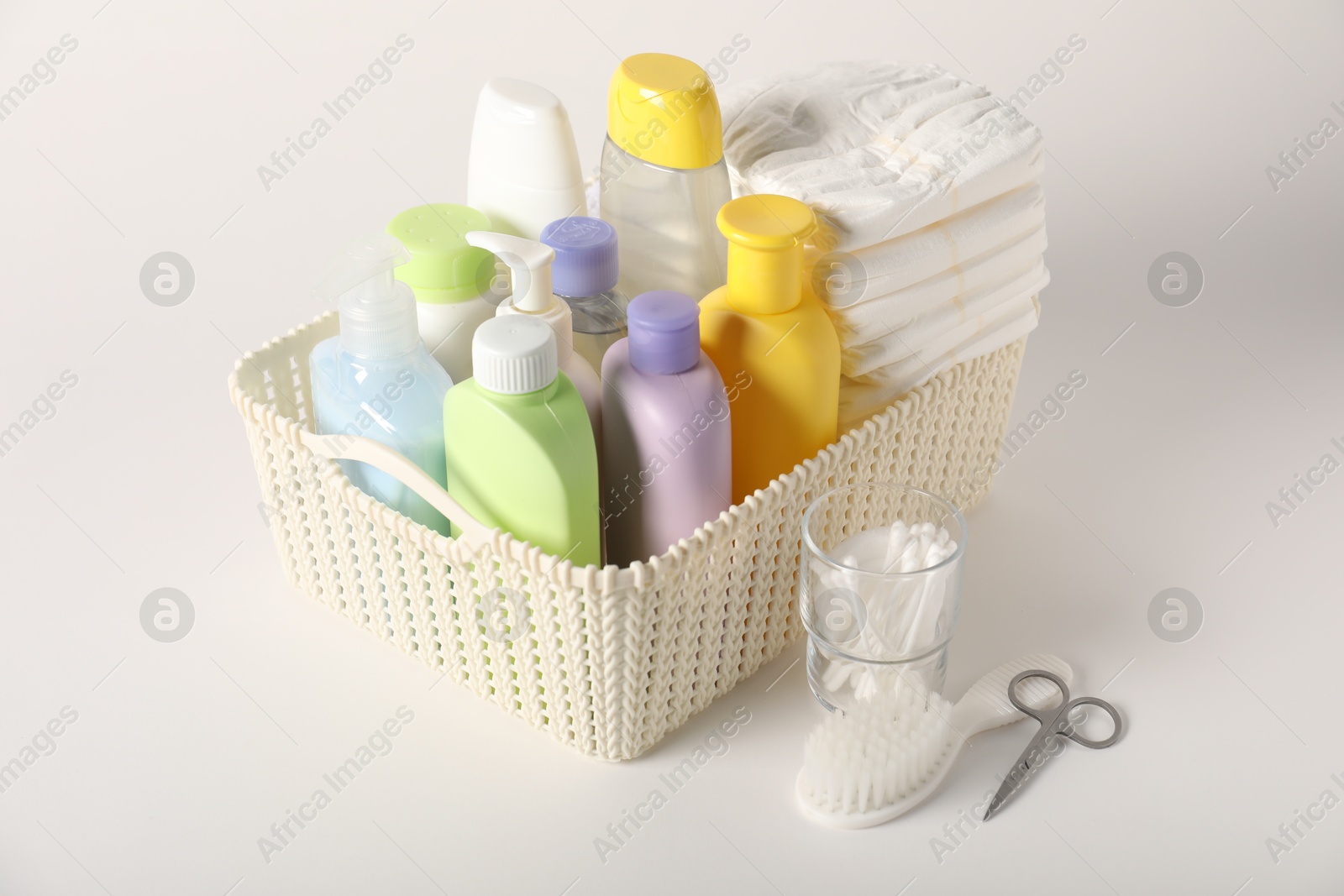 Photo of Baby accessories and body care products on light background