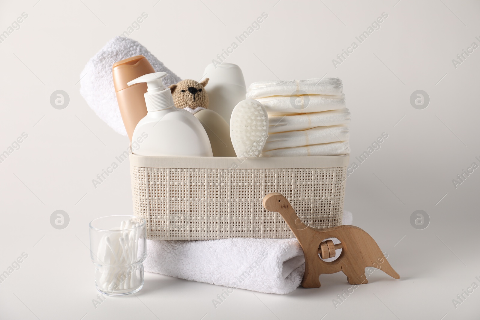 Photo of Baby accessories and body care products on light background