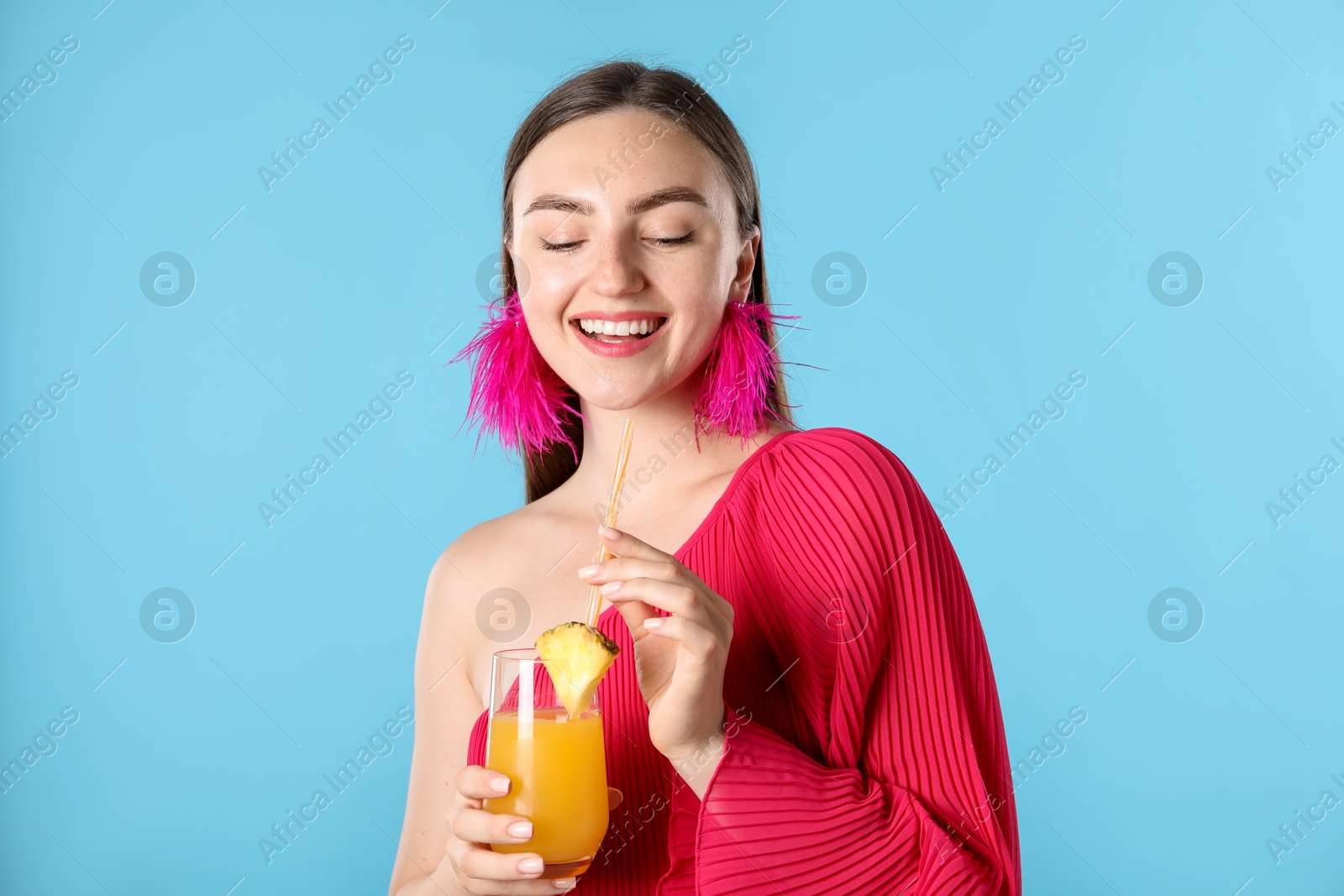 Photo of Woman with refreshing drink and straw on light blue background