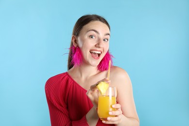 Photo of Woman with refreshing drink and straw on light blue background