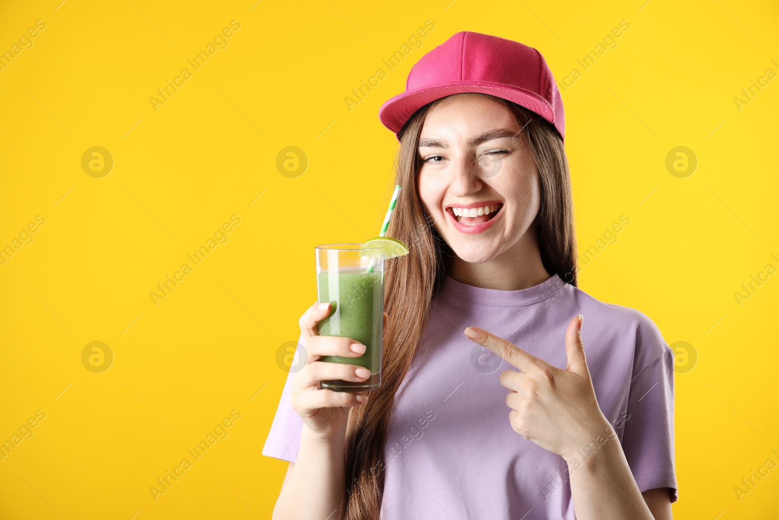 Woman with refreshing drink and straw on orange background, space for text Photo of Woman with refreshing drink and straw on orange background, space for text