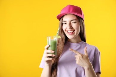 Photo of Woman with refreshing drink and straw on orange background, space for text