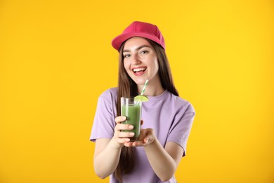 Photo of Woman with refreshing drink and straw on orange background