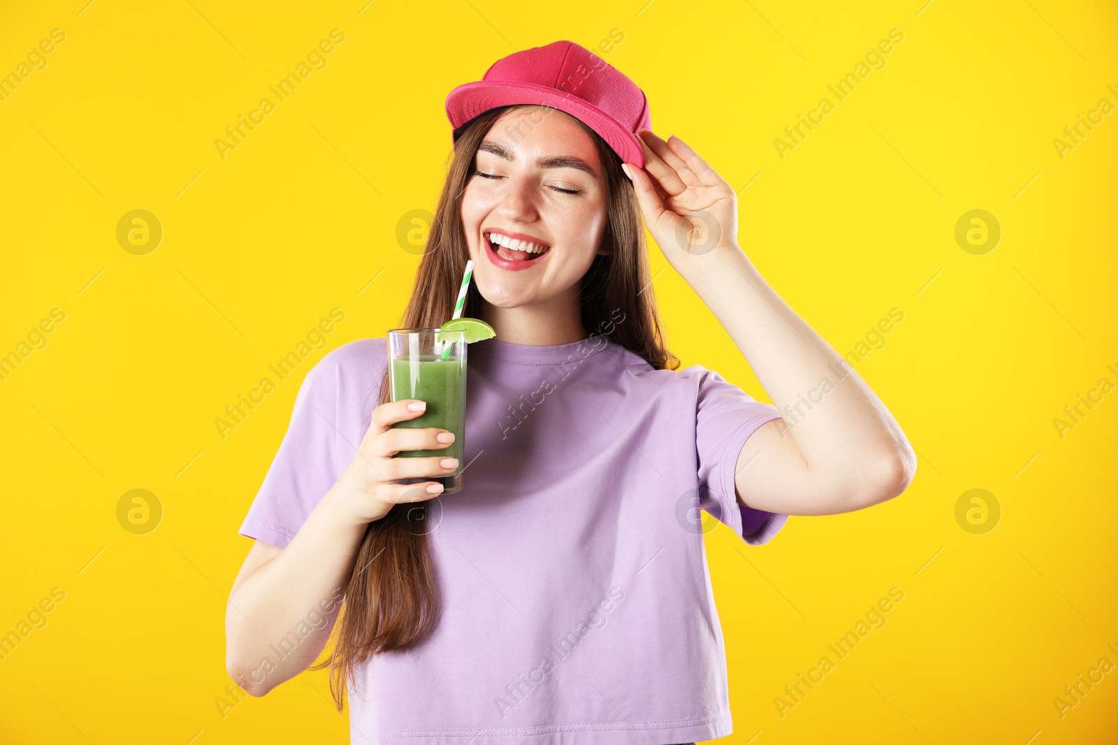 Photo of Woman with refreshing drink and straw on orange background