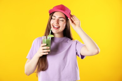 Photo of Woman with refreshing drink and straw on orange background