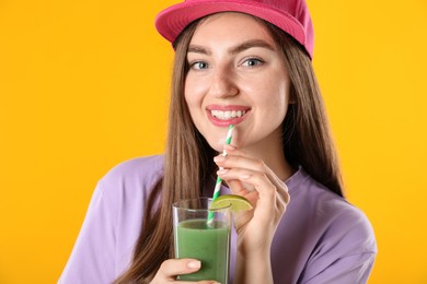 Photo of Woman with refreshing drink and straw on orange background