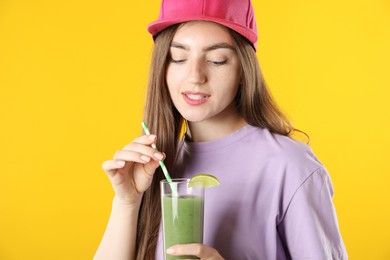 Photo of Woman with refreshing drink and straw on orange background