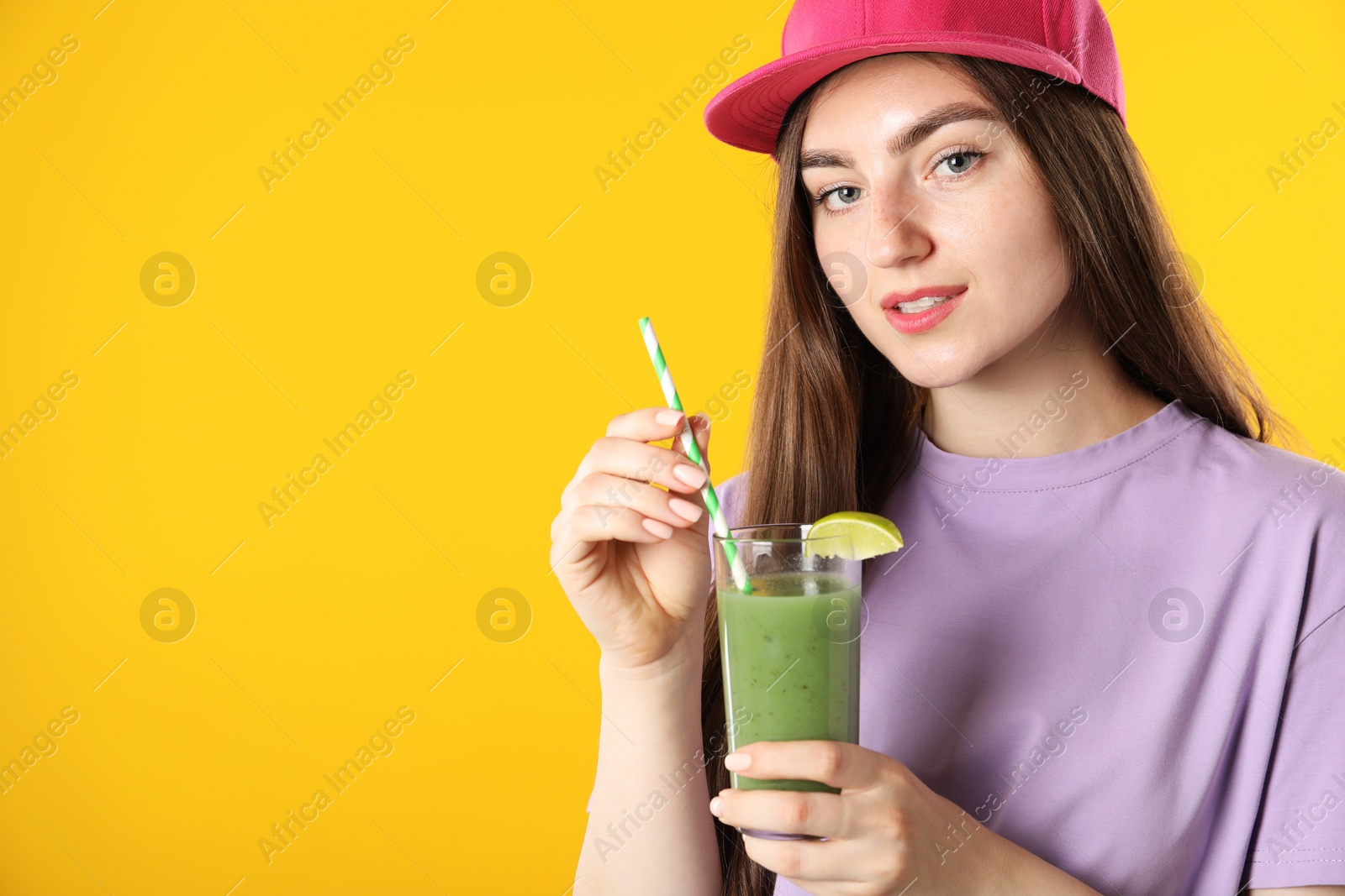 Photo of Woman with refreshing drink and straw on orange background, space for text