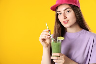 Photo of Woman with refreshing drink and straw on orange background, space for text