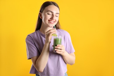 Photo of Woman with refreshing drink and straw on orange background